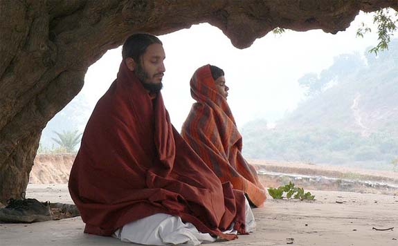 Meditating practitioners in a cave